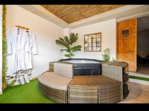 a living room with a chair and a couch at Nuit romantique avec spa privatif in Meilhaud