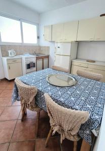 a kitchen with a table with chairs and a plate on it at Studio Apartmani Šehić in Krvavica