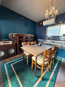 a dining room with a wooden table and chairs at YAMAGAWA Okesho - Vacation STAY 38332v in Niijimamura