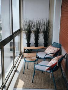 two chairs and a table on a balcony with plants at Stylish Comfort in Mandelieu in Mandelieu-la-Napoule