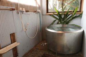 a bathroom with a plant in a large tub at Sangosho in Kerizaki
