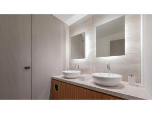 two sinks in a bathroom with two mirrors at Sun Hotel Fukuyama - Vacation STAY 53469v in Fukuyama