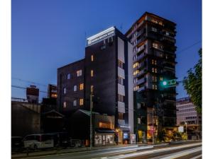a tall building on a city street at night at SAUNA HOTEL GIFU - Vacation STAY 48263v in Gifu