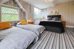 Ένα ή περισσότερα κρεβάτια σε δωμάτιο στο Rowcroft Lodge Guest House B&B +125 φωτογραφίες