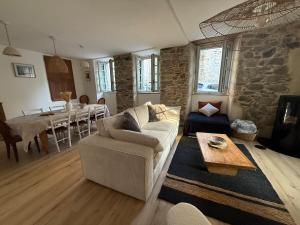 a living room with a couch and a table at La Belle Auroise in Arreau