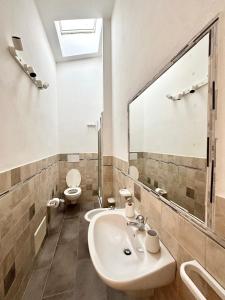 a bathroom with a sink and a toilet at Badesi Sunset View in Badesi
