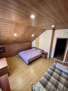 two beds in a large room with wooden ceilings at Villa Costa in Sanzhiyka +53 photos