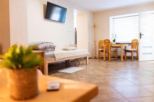 a living room with a table and a dining room at Apartament 592 in Boguszów-Gorce