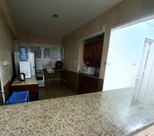 a kitchen with a granite counter top in a room at Blue calm chalet in Dawwār Abū Maḩrūs