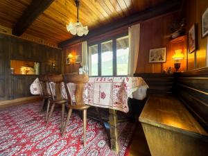 a dining room with a table and chairs at Chalet les Mélèzes - Typique, terrasse & cheminée in Liddes