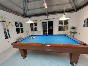 a pool table in the middle of a room at Farm 110 Resort in Amadeo +5 photos