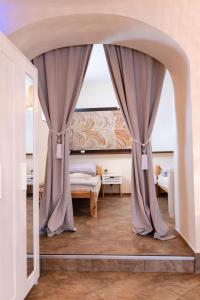 a bedroom with a bed and a large window at Apartament 592 in Boguszów-Gorce