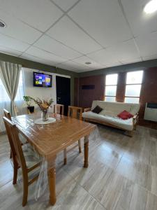 a living room with a wooden table and a couch at Departamento Boulevard in Malargüe
