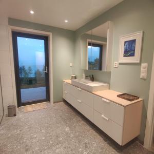 a bathroom with a sink and a mirror at Villa by the sea in Vesterålen  +43 photos