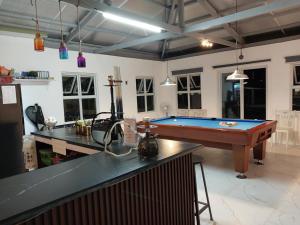 a kitchen with a pool table in a room at Farm 110 Resort in Amadeo