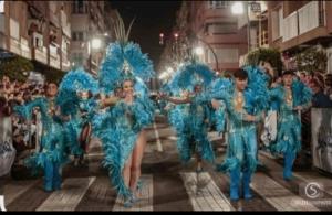 a group of women in blue costumes walking down a street at APARTAMENTO SOL - 2 apartamentos céntricos juntos cerca de la playa, ideales para grupos grandes in Águilas