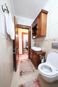 a bathroom with a toilet and a sink at Ayşem Mill Hill Houses in Bodrum City +72 photos