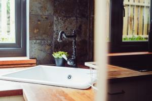 a sink in a kitchen with a faucet at Cottage near Matlock Bath & Cromford in Middleton +28 photos