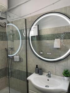 a bathroom with a sink and a mirror at Callisti Lux Apartment in Nei Poroi