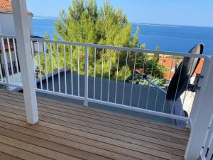 a railing on a balcony with a view of the ocean at Zaglav Iva in Martinšćica