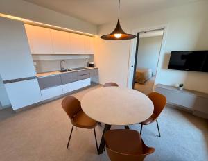 a kitchen with a table and chairs in a room at Suite Apartments Prestige in Bellaria-Igea Marina