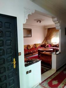 a room with a couch and a table and a door at Superbe appartement proche de toutes les commodités Salé in Sale