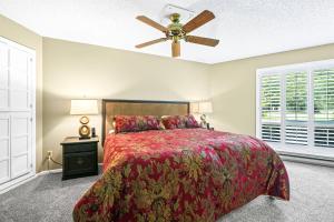 a bedroom with a bed and a ceiling fan at Fairway Forest Retreat! in Welches