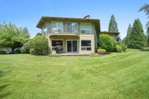 a large house with a lawn in front of it at Fairway Forest Retreat! in Welches