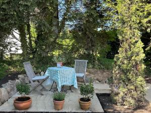 a table and two chairs with a tea pot on it at Sailors Retreat in Strande