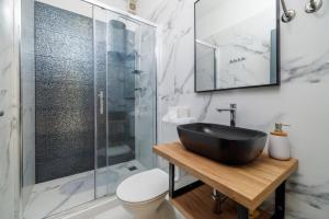 a bathroom with a sink and a glass shower at Apartments Domagoj in Lukovo Šugarje +90 photos