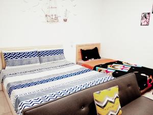 Postel nebo postele na pokoji v ubytování Yu Hai B&B