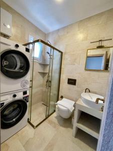 a bathroom with a shower toilet and a sink at Çam Tatil Evleri in Datca
