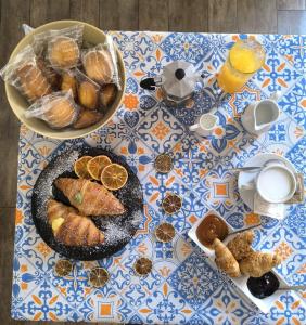 a table with a plate of pastries and oranges on it at Casa Rustica in Conversano +14 photos