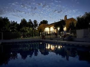 a swimming pool in front of a house at Casa Rosi in Yecla