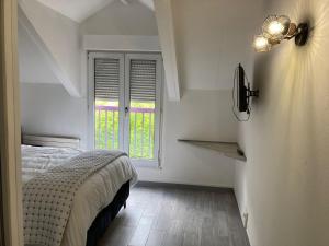 a bedroom with a bed and a phone on a wall at HSH France Chambre City 3 Proche de Disney in Meaux
