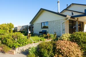 a house with bushes in front of it at Treetops in Blenheim