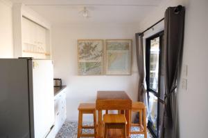 a kitchen with a table and chairs and a refrigerator at Treetops in Blenheim +26 photos