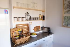 a kitchen counter with a bowl of fruit and a microwave at Treetops in Blenheim