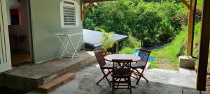 a table and chairs on a patio with a view at L'ambre in Deshauteurs