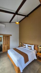 a bedroom with a large bed with white sheets at MyHome - Lombok in Tetebatu +99 photos