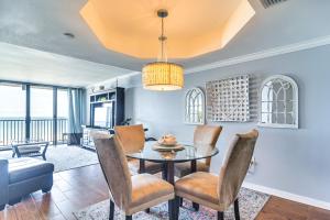 a dining room with a table and chairs at Walk to Beach and Eats Condo with Pool in Clearwater! in Clearwater Beach