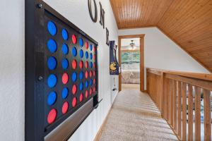 a hallway with a giant board game on the wall at Whispering Creek - In the Heart of Ozarks Near Downtown in Reeds Spring
