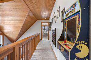 a hallway with a pin bowling game on the wall at Whispering Creek - In the Heart of Ozarks Near Downtown in Reeds Spring