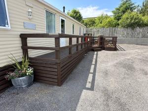 a large wooden deck on the side of a house at Cozy Donegal Caravan in Dunkineely