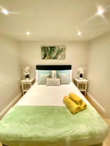 a bedroom with a large bed with two end tables at Luxury Penthouse 3-Bedrooms Private in London