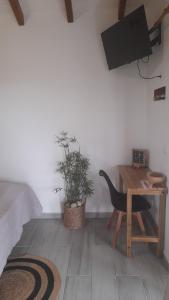 a bedroom with a desk and a chair and a table at Bwa Ka - Havre de paix et cosy in Saint-François