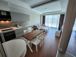 a kitchen and living room with a table and chairs at Antalya Sirius Town Residence in Antalya