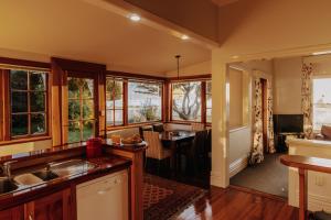 a kitchen with a table and a dining room at Beachfront Villa, Spacious, Mountain Outlook - KK87184 in Kaikoura