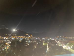 a view of a city at night with a street at Los ROYALS Hotel Huaraz in San Antonio