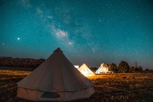 a tent in a field under a starry sky at Starlight Glamping Grand Canyon in Valle +7 photos